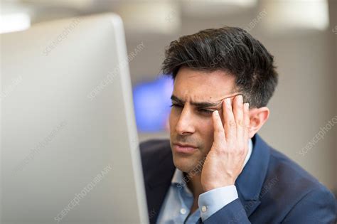 Confused Businessman Looking At Computer In Office Stock Image F020