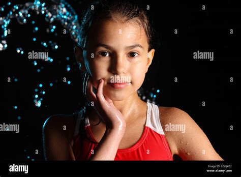 close up portrait of a beautiful teenage girl against the background of splashes of night rain