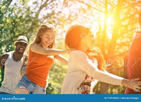 Multiracial Friends Dancing In Garden Party During Summer Time