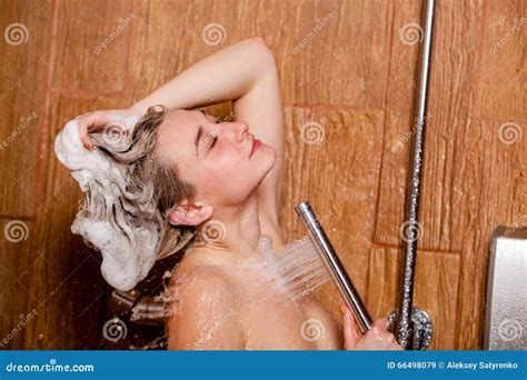 Beautiful Woman Standing At The Shower She Holds In Her Hand Showerhead Stock Image Image Of