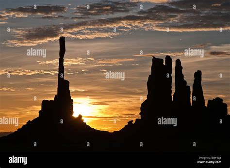 Sunrise With Totem Pole Rock Formation In Backlight Monument Valley