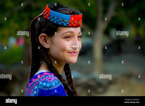 A Beautiful Kalasha Girl Smiles As She Passes A Forest In Kalash Valley