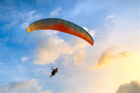 Premium Photo Paraglider Soaring In The Blue Sky