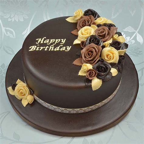 A Chocolate Cake With Yellow And Brown Flowers On Top