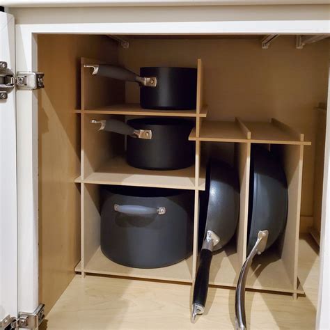 As such, you need a good pan organizer to help keep your kitchen and cookware in perfect order. Kitchen Cabinet Pot and Pan Storage Organizer - The Steady ...