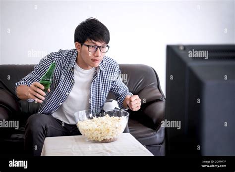 Indian Man Eating Popcorn Watching Hi Res Stock Photography And Images
