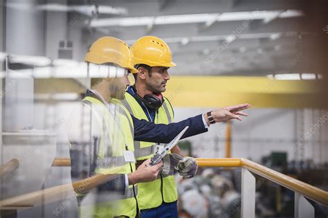 Male Supervisors Talking On Platform In Factory Stock Image F030