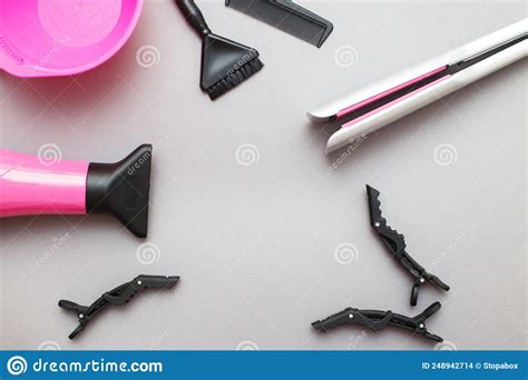 Various Hairdressing Tools Like Hair Dryer Comb On A Gray Background