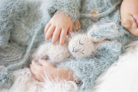 Newborn Baby Sleeping Baby In Bed Holding A Bunny Toy Stock Image