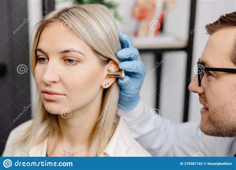 Otolaryngologist Doctor Checking Young Woman S Ear Using Otoscope Or