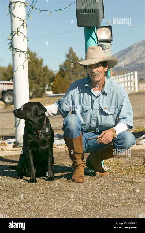 Cowboy With His Dog Kneel Down At The Sands Motel At The Intersection