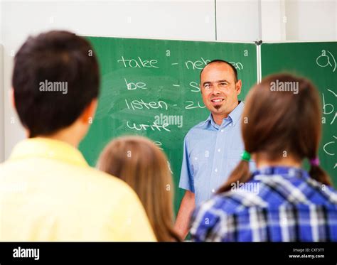 Teacher Teaching At The Blackboard Stock Photo Alamy