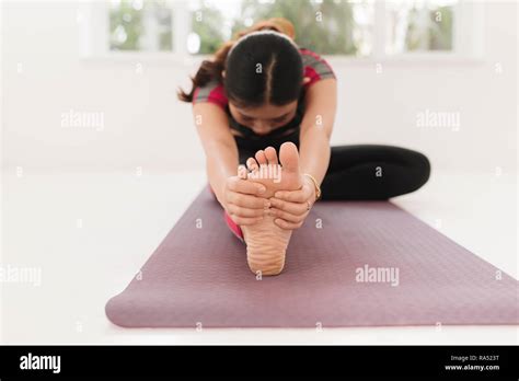 Young Attractive Yogi Woman Practicing Yoga Concept Sitting In Janu