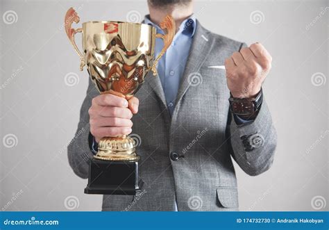 Businessman Holding Golden Trophy Business Success Stock Photo