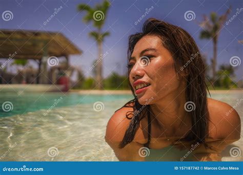 Young Beautiful And Happy Asian Indonesian Woman In Bikini Swimming In
