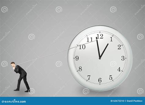 Stop Timing Concept With Businessman Trying To Stop The Time Stock