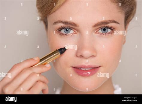 Portrait Of A Beautiful Woman Applying Concealer Stock Photo Alamy