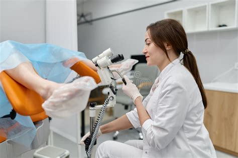 Gynecologist Examining Patient On Chair With Gynecological Microscope Stock Image Image Of