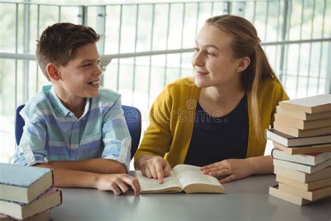 Smiling School Kids Reading Books In Library At School Stock Image