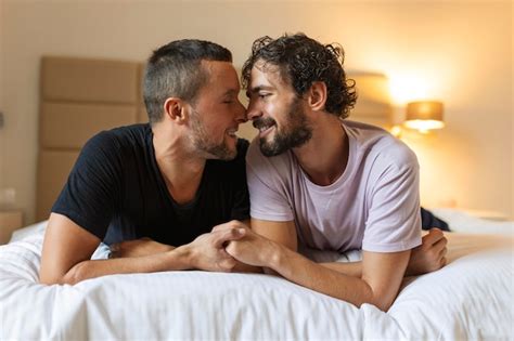 Premium Photo Happy Gay Couple Lying Down On The Bed At Home Hugging And Flirting Lgbt Gay