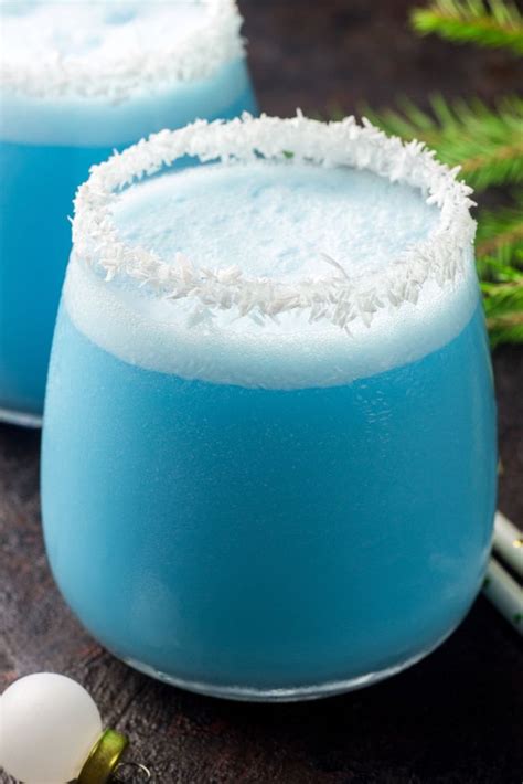 Combine all ingredients over ice in a glass. Close up of a Jack Frost Cocktail with a coconut rim ...