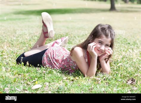 Happy Cute Girl Laying On A Grass Field And Looking Stright Outdoor