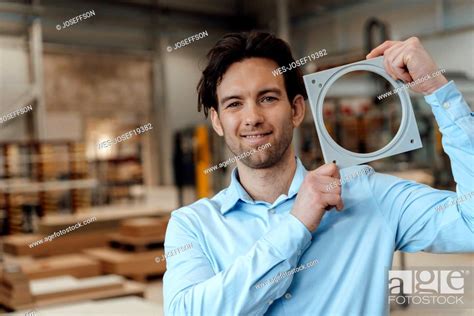 Happy Businessman Showing Machine Part Stock Photo Picture And