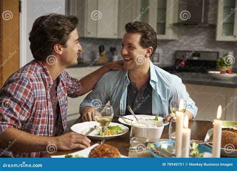 Male Gay Couple Having A Romantic Dinner In Their Kitchen Stock Image