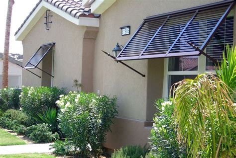 The brackets and fixing bars that attach the awning above the door or window are sturdy and rust resistant. Bahama Exterior Shutters | Shutters exterior, Outdoor shutters, Bahama shutters