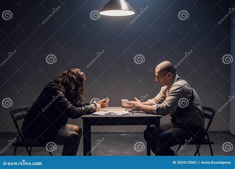 In The Interview Room A Handcuffed Suspect Meets With A Police Or Fbi Detective Investigator