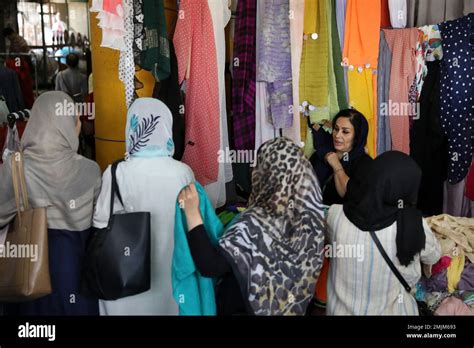 A Vendor Sells Scarves To Customers At His Stall At Jomeh Bazaar Or
