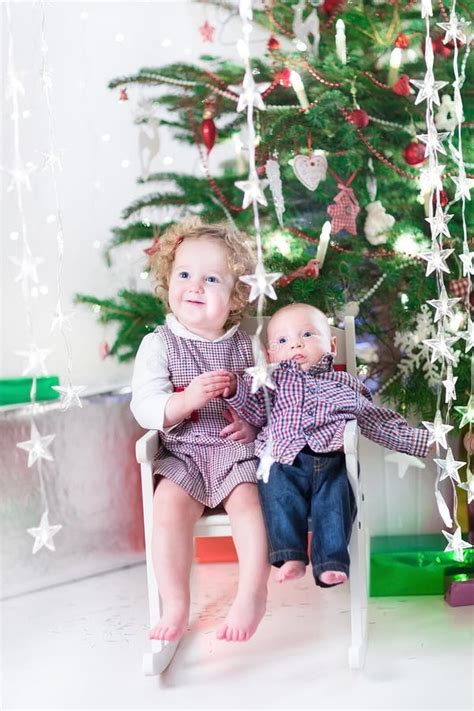 Cute Laughing Toddler Girl And Her Little Baby Brother Under Christmas