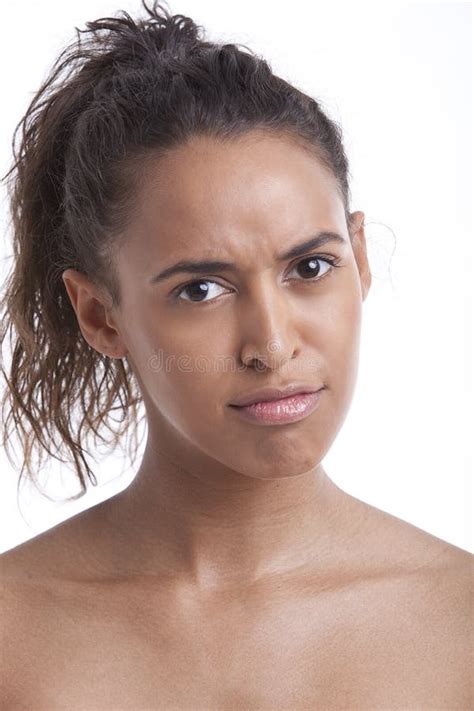 Portrait Of Young Mixed Race Woman Pouting Against White Background