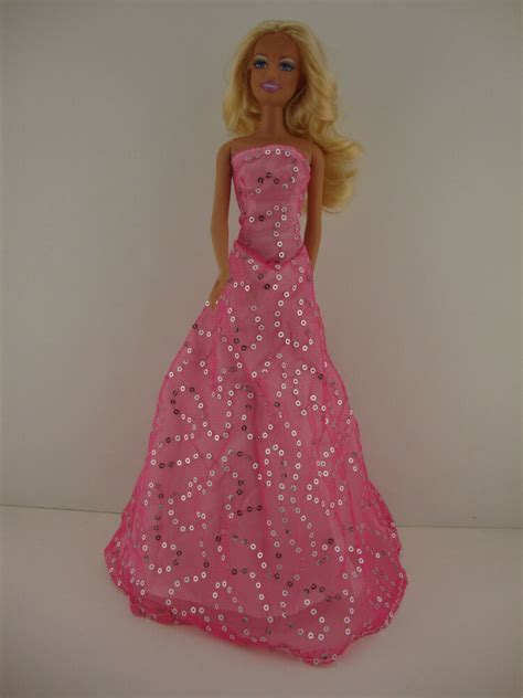 A Light Pink Dress With Lots Of Sparkle Made To Fit The Barbie Doll