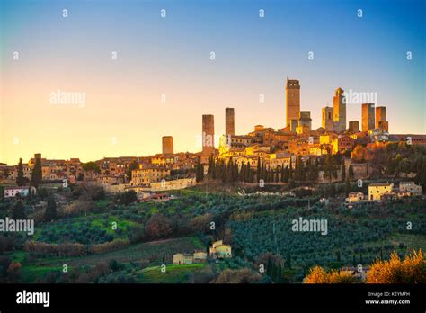 san gimignano town skyline and medieval towers sunset italian olive trees in foreground