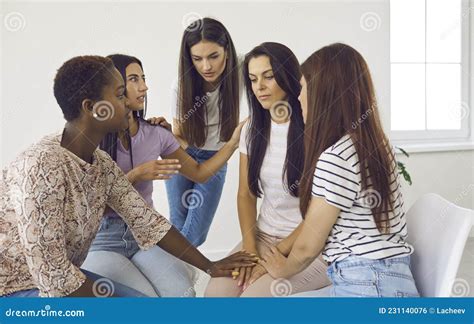 Group Of Women Comforting Depressed Friend Talking About Her Problems