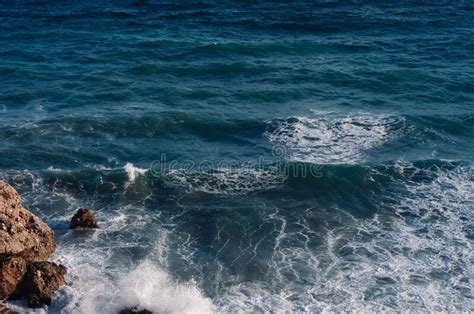 Aerial Drone View Of The Ocean And Waves Crashing On Rocks Stock Photo