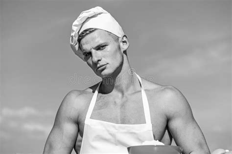 Man On Confident Face Wears Cooking Hat And Apron Sky On Background Cook Or Chef With Muscular