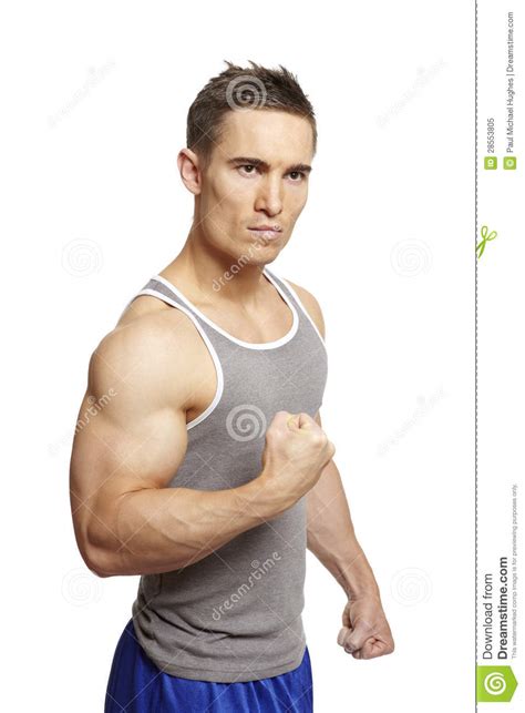 Muscular Young Man Flexing Arm Muscles In Sports Outfit Royalty Free