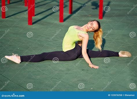 Stretching Gymnast Woman Doing Split Twine In Workout Sports Ground