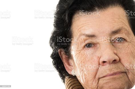 Portrait Of Grandmother Looking Nostalgic At Camera Stock Photo