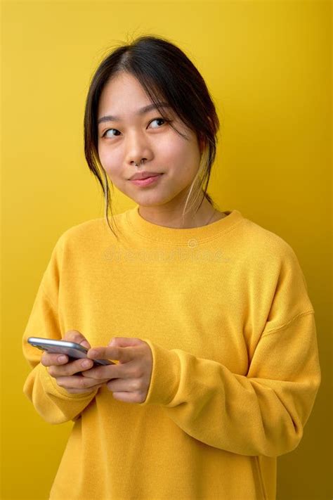 Photo Of Adorable Asian Lady Holding Telephone In Hands Reading New Positive Comments Stock
