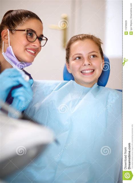 Dentist With Young Female Patient In Dental Clinic Stock Image Image