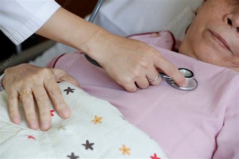 Doctor Checking Womans Heartbeat With Stethoscope Stock Image C050