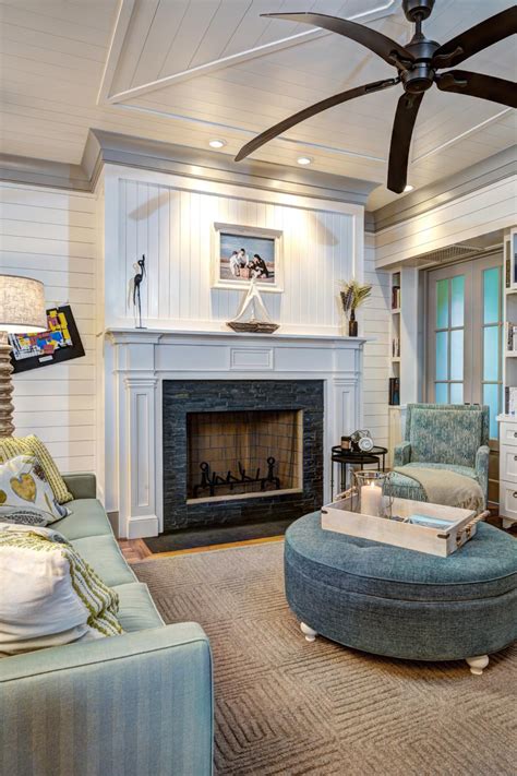Living Room With Tiled Fireplace Large Ceiling Fan And Coastal Accents