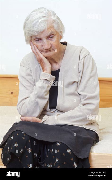 Portrait Of An Elderly Woman Sitting On The Bed Stock Photo Alamy