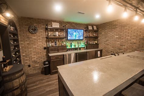 A wet bar is right there at the top of the wish list for a lot homeowners finishing the basement! South Lyon, MI Walkout Basement With Industrial Bar ...