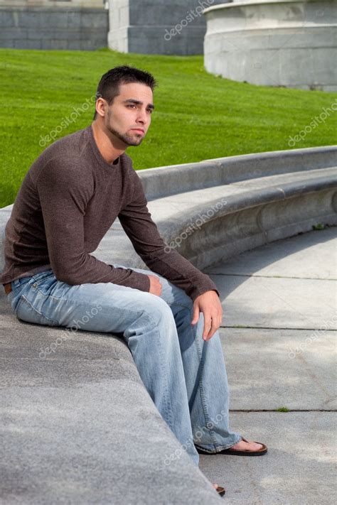 Young Man Sitting Outsitde On Concrete Bench — Stock Photo © Nickp37