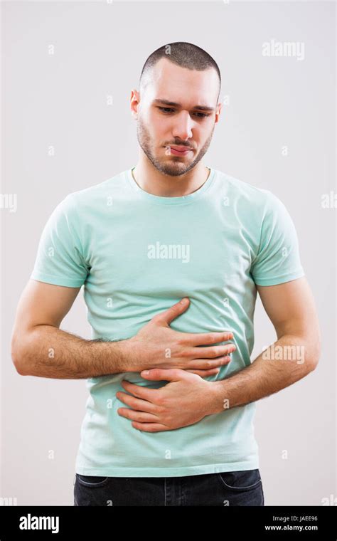 Man Holding Stomach In Pain Hi Res Stock Photography And Images Alamy
