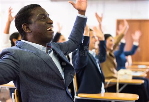 Excited African American Man Sitting With Raised Hands During Prayer